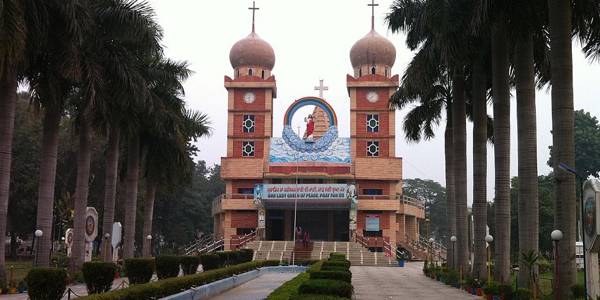 A picture of a church taken from the front with a walkway leading to its entrance