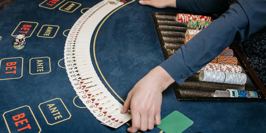 A glimpse of a dealer shuffling and displaying the cards on the table in a leisure hub.