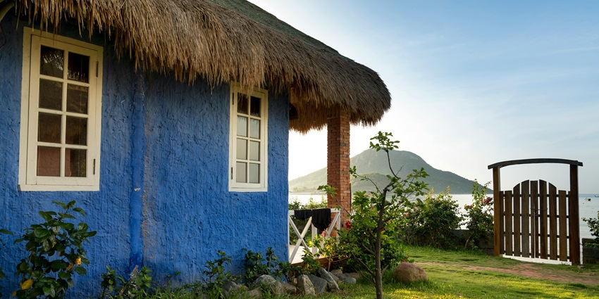 Image of Blue Painted House With Hay Roofing - one of the best things to do in Mulshi