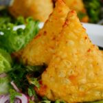 Samosa served with chutney and onions, one of the most delicious street food in Panchkula