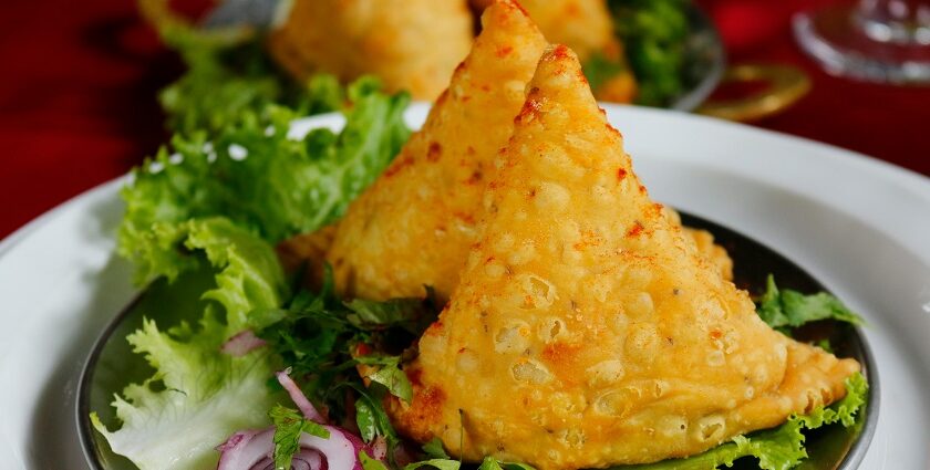 Samosa served with chutney and onions, one of the most delicious street food in Panchkula