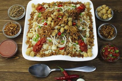 Snapshot of the Koshary on a ceramic plate served on the table of a restaurant