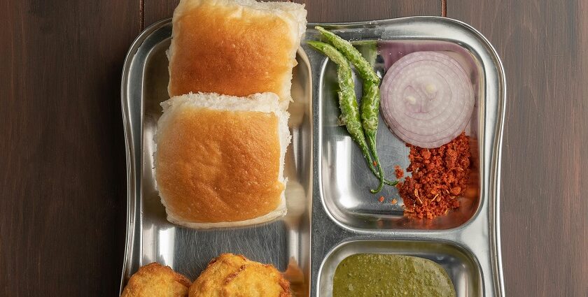 Glass jars filled with different items and man cutting tomato for bhelpuri preparation