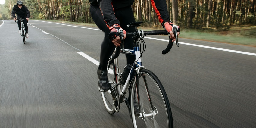 Image of two people on e-bikes riding through the forest paths for picturesque views