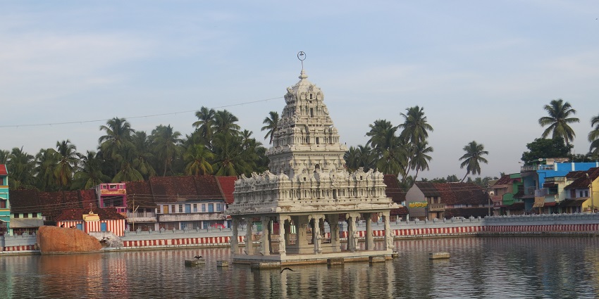 Image of Suchindram Temple on a lake during evening time near Olakaruvi Waterfall