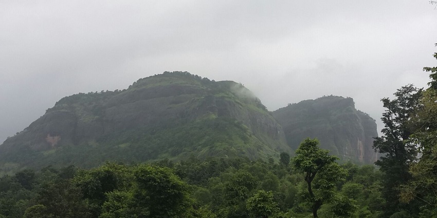 Majestic view of Sudhagad Fort amidst lush greenery and scenic landscape