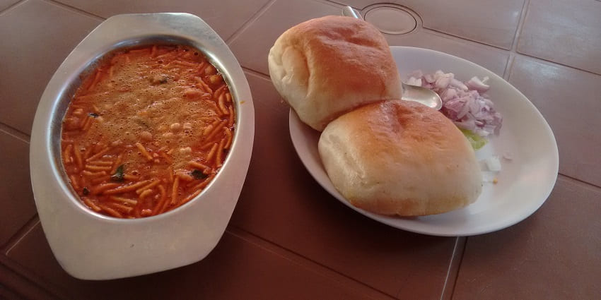 A platter of spicy Solapuri misal served with bread, the best food in Solapur.