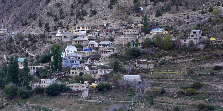 A picture of a village near the Chumathang hot spring with residential apartments all around