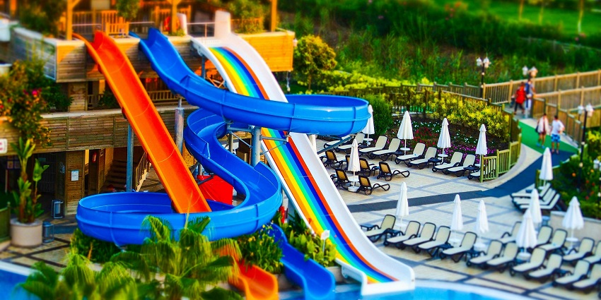 A view of Two girls swimming at a Suraj Water park in Kalyan features clear blue pool.