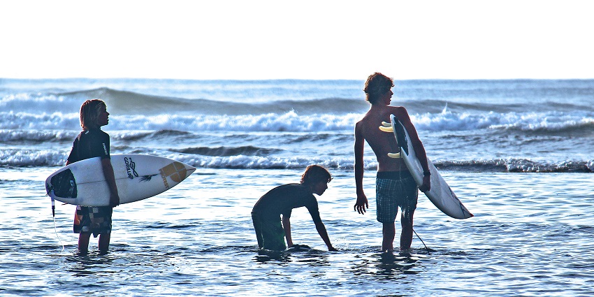 The three young surfers' picture was taken while practicing surfing, one of the things to do in Canggu.