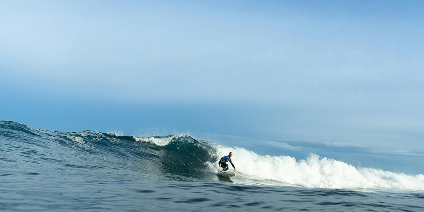 A thrilling image of surfers surfing at Bingin Beach.
