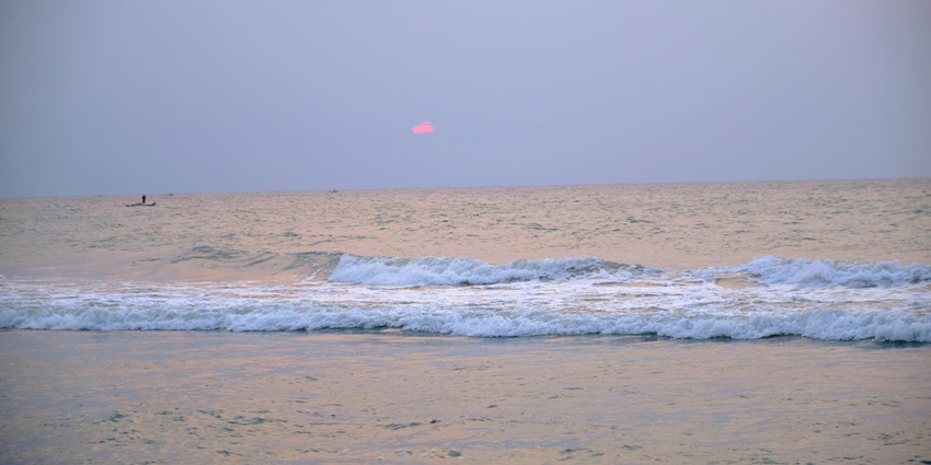 An image of the shore of a beach with the waves hitting, similar to Suruchi Beach