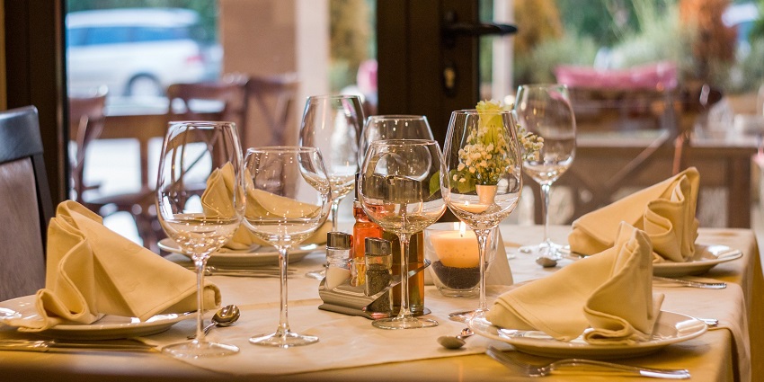 People dining on the beautiful outdoor seating of a restaurant with a lively atmosphere.