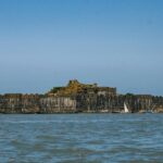 Panoramic view of the iconic Suvarnadurg Fort across the river body in Maharashtra