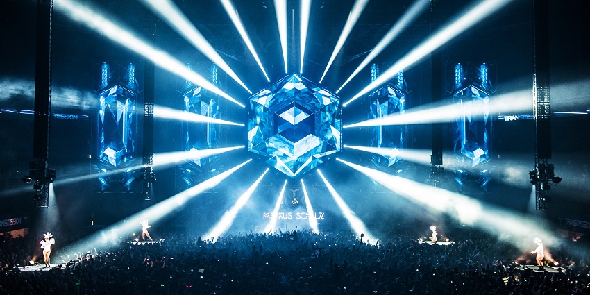 A large stage with lights illuminating the place with energy and vigor