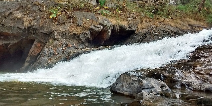 Syntheri Rock offers towering cliffs, a waterfall, lush greenery, and serenity to visitors.