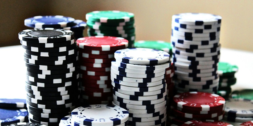 An image of Poker coins, also known as poker chips, are round tokens used in place of money.