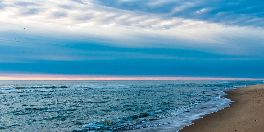 A secluded stretch of white sand and turquoise waters at Paradise Beach in Gokarna