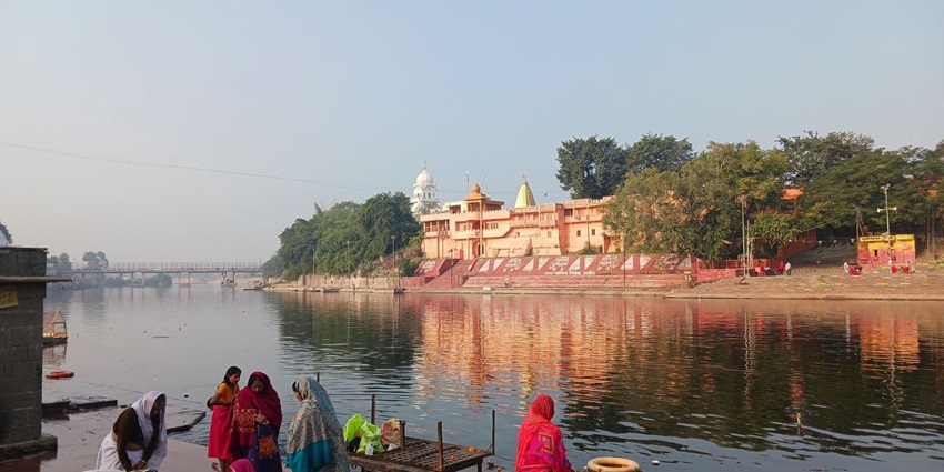 An image showing devotees taking a holy dip at Ramghat Ghat as part of the things to do in Ujjain.