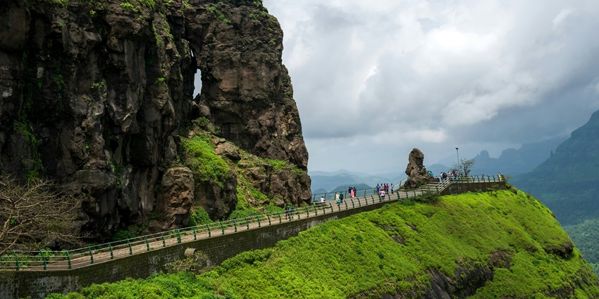 An astonishing view of the Malshej Ghat featuring lofty peaks and lush greenery.