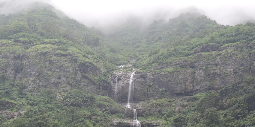 A calm view of Zenith Waterfall, cascading down surrounded by greenery in Khopoli.