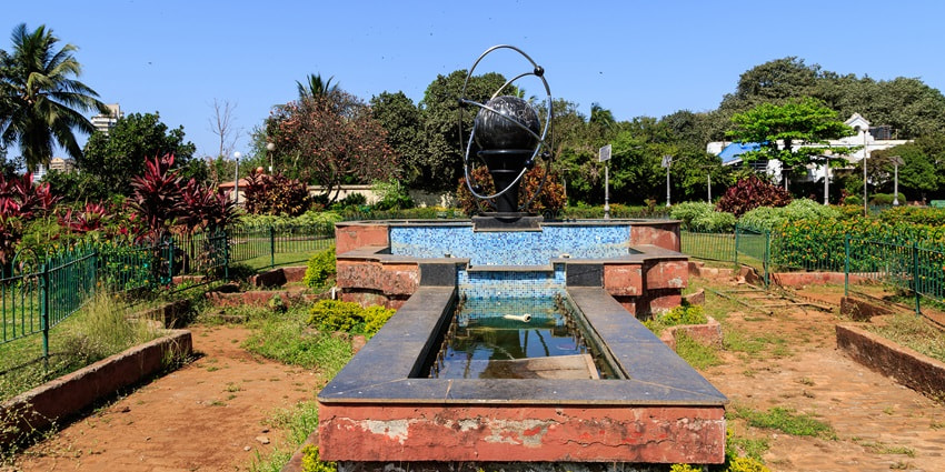 A picture of a sculpture in the middle of Mumbai’s Hanging Gardens with greenery all around