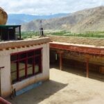 Panoramic view from roof of Thagthok Gompa showing courtyard and wall paintings-Takthok Monastery