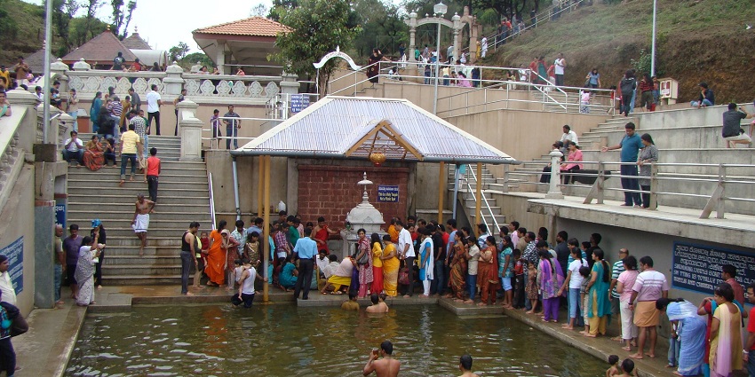 Talakaveri Temple in Karnataka, a serene site surrounded by greenery.