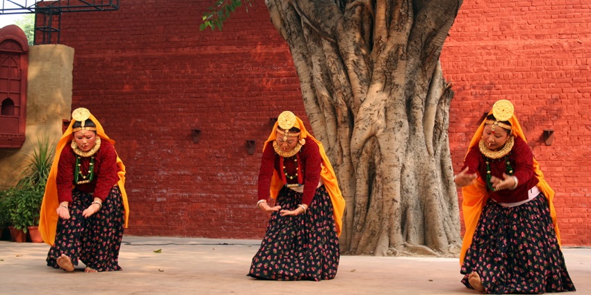 A picture of Sikkimese women celebrating the harvest festival with a traditional dance performance