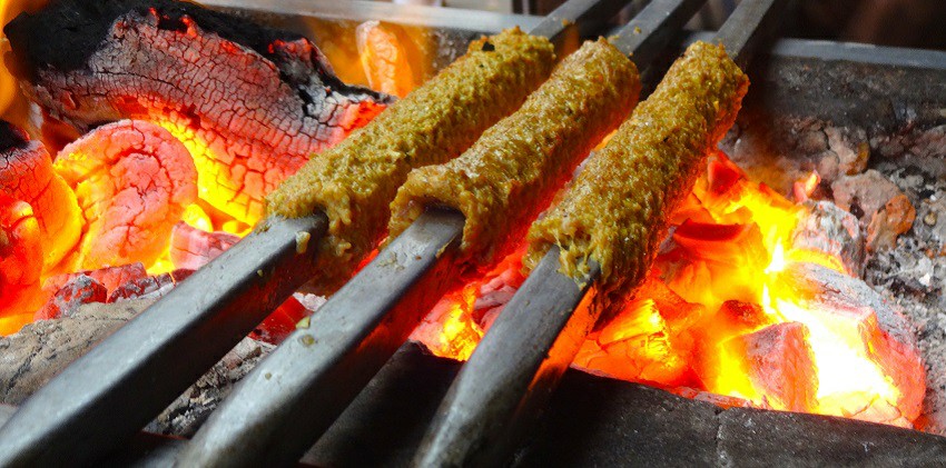 Seekh Kebabs, made of spiced meats on metal rods grilled on an open coal fire.