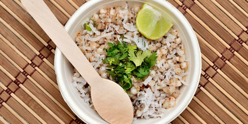 Sabudana Khichadi topped with grated coconut, coriander leaves and lemon served in a bowl