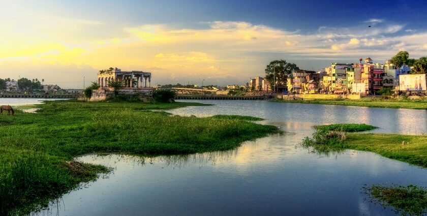 A beautiful sunrise over the Vaigai River in Madurai, Tamil Nadu, surrounded by greenery.