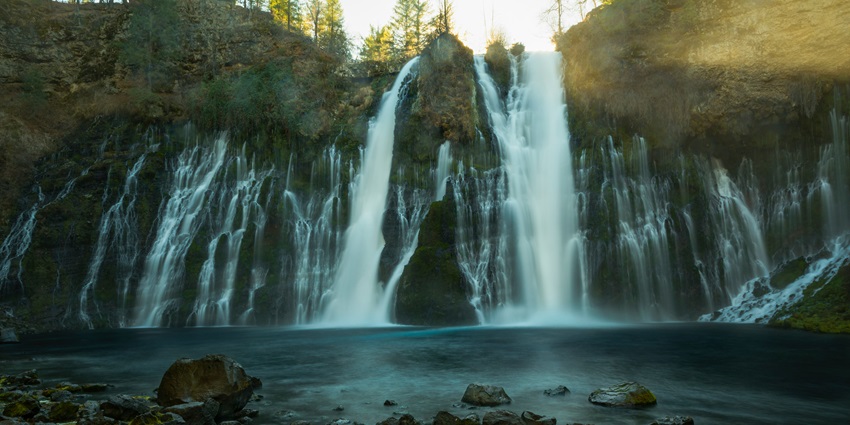 Thalliar Falls (Rattail Falls), surrounded by dense greenery in a natural setting.