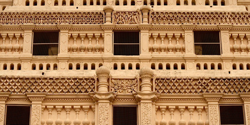 The architecture of the stunning Thanjavur Royal Palace with intricate carvings.