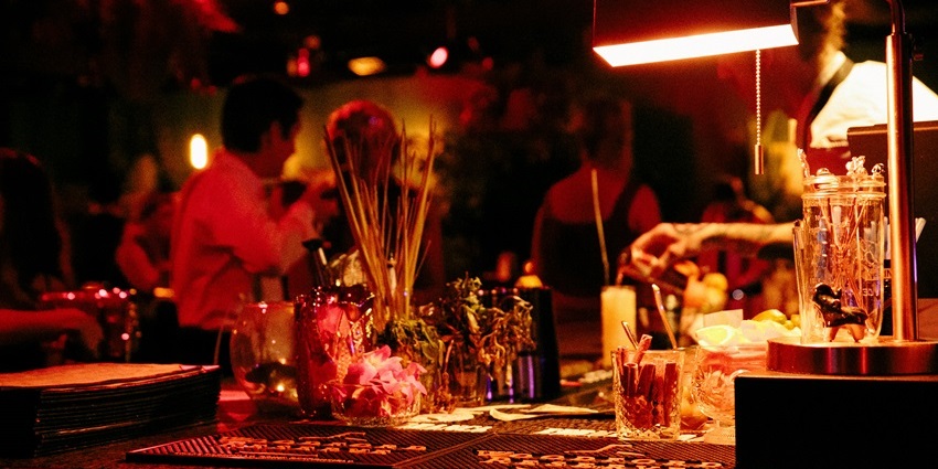 A picture of a dining table at a restaurant in Candolim under a dimly lit ambience