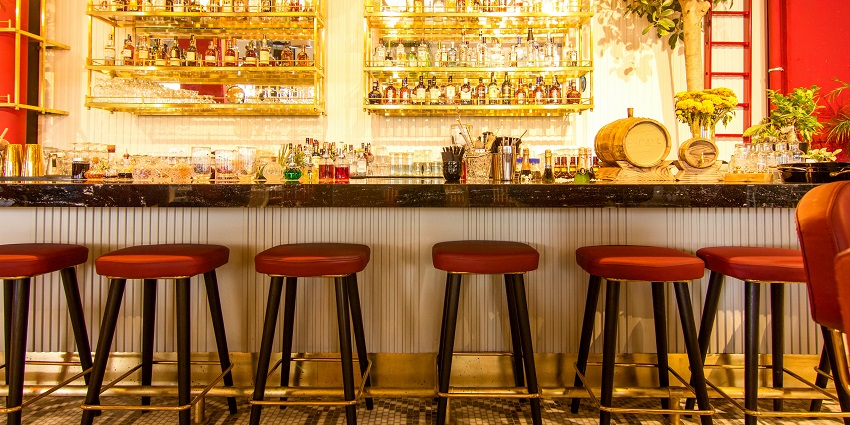 Image of brown and white counter table and six brown high chairs and vibrant lights