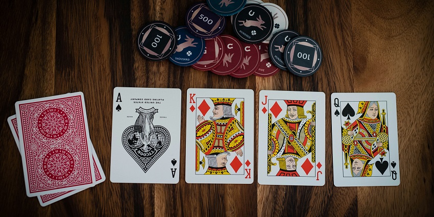 An inside view of The Ritz Club, London, UK featuring a poker table and cards.