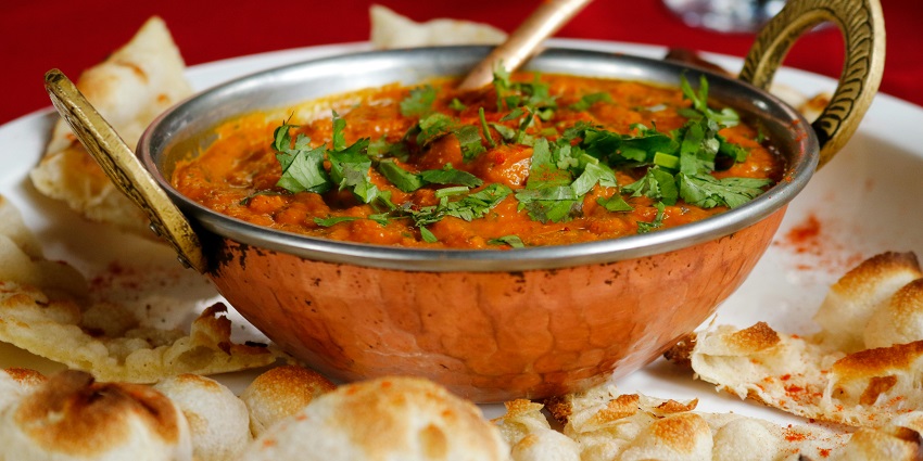 A plant-based meal is presented on a platter consisting of mushrooms and sweet potato