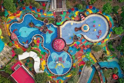 An aerial view of a floral-shaped pool and slides at an international water park