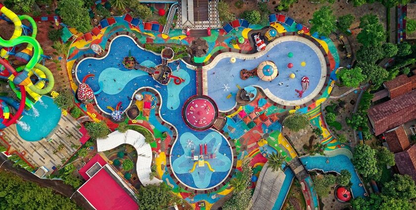 An aerial view of a floral-shaped pool and slides at an international water park