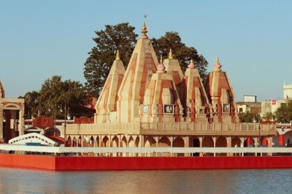 A scenic glimpse of a pristine temple in Haryana surrounded by shimmering blue waters.