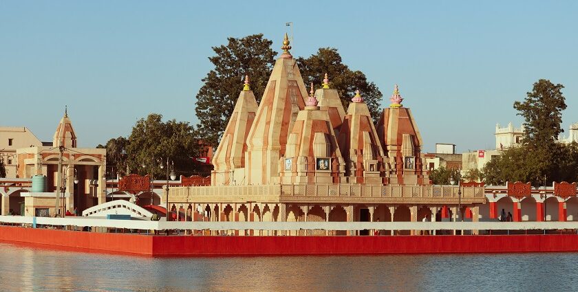 A scenic glimpse of a pristine temple in Haryana surrounded by shimmering blue waters.