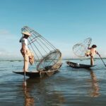 The fishermen throws the net to catch the fish on the beach of Kuta, Indonesia.