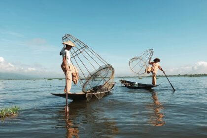 The fishermen throws the net to catch the fish on the beach of Kuta, Indonesia.