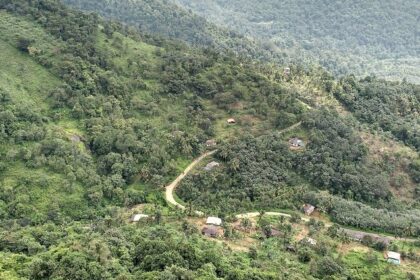 A scenic view of Madikeri village surrounded by green hills and mist–Things to do in Madikeri