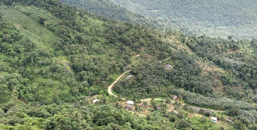 A scenic view of Madikeri village surrounded by green hills and mist–Things to do in Madikeri