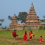 A picture of people walking in the garden of the ancient Shore Temple of Mahabalipuram.