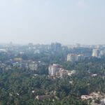 View of Mangalore skyline with vibrant sunset and urban architecture.