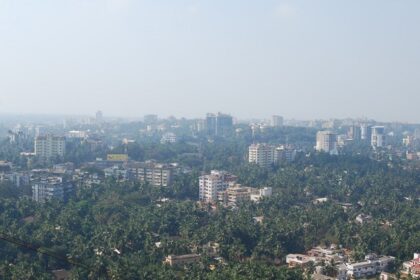 View of Mangalore skyline with vibrant sunset and urban architecture.