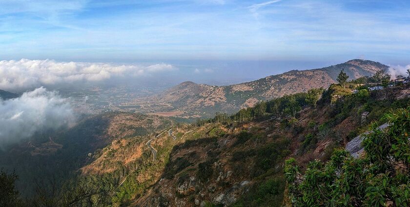 A breathtaking vista of green-capped mountains surrounded by lush green vegetation.